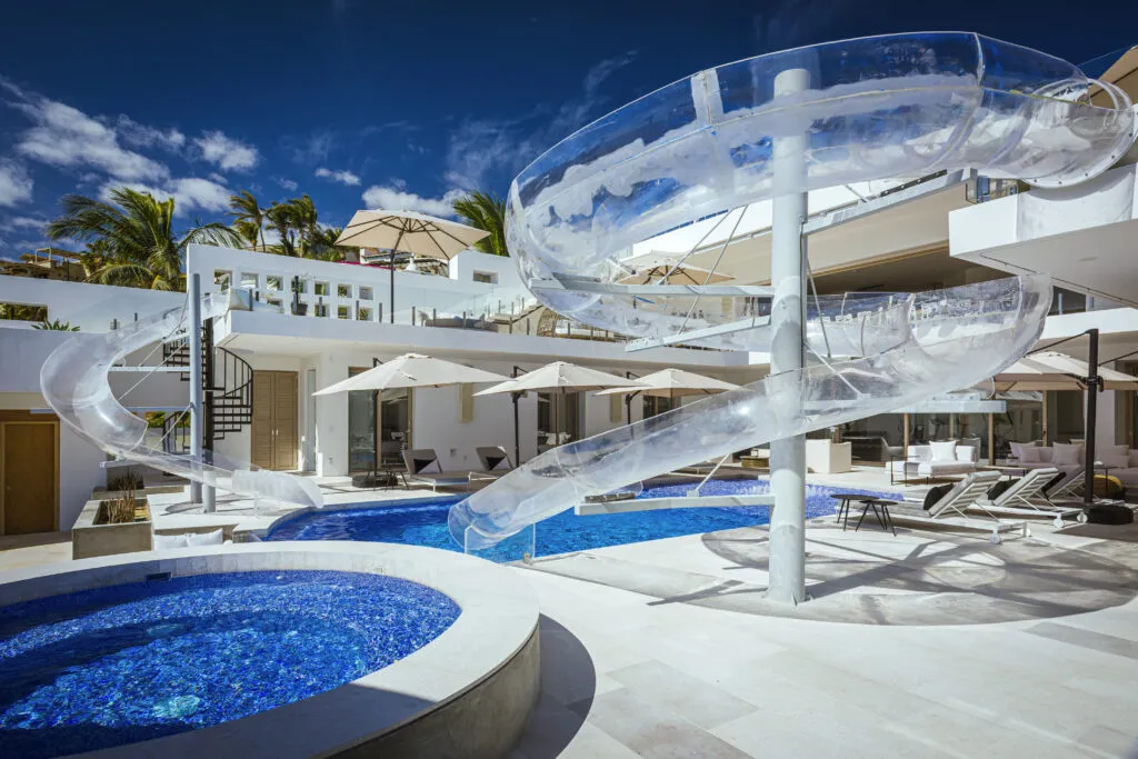 Twin acrylic pool slides connecting the rooftop terrace to the pool at Casa Aqua Blanca, Punta Bella