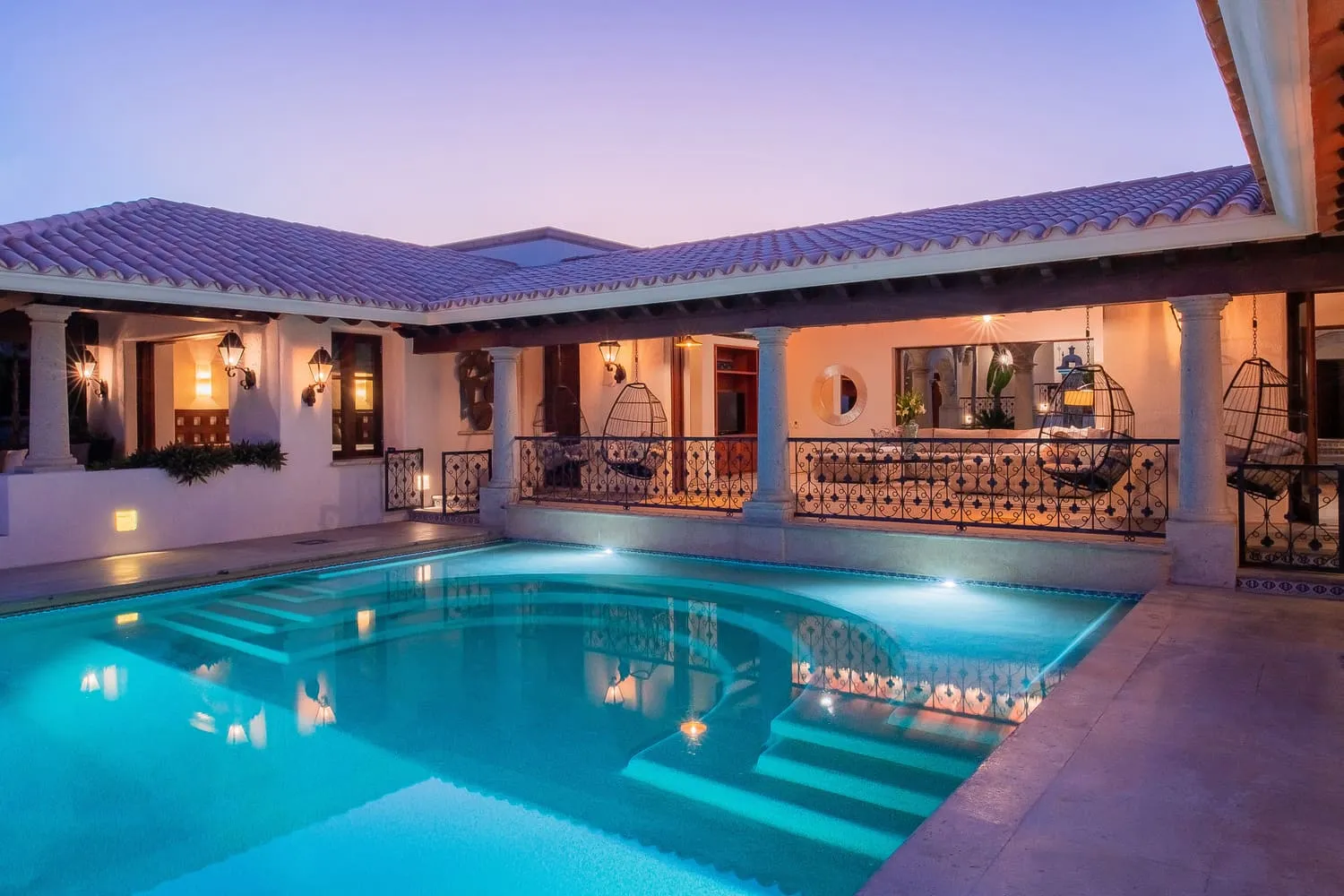 Private swimming pool at Casa Brooks illuminated in the evening