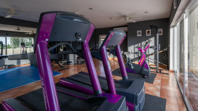 caminadoras gimnasio dunas condo Professional-grade treadmills and a stationary bike in the vacation complex's gym.